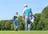 Father and son walking with gold bags on gold course