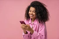 Beautiful smiling woman using smartphone to buy eGifts