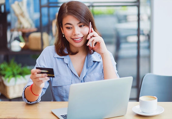 woman on phone checking five back balance