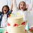 Birthday cake with happy children in the background