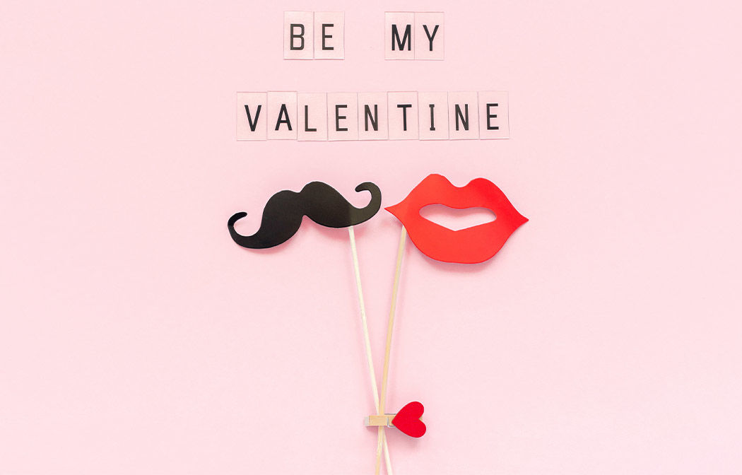 Pink card with a mustache and lips and says 'Be My Valentine'