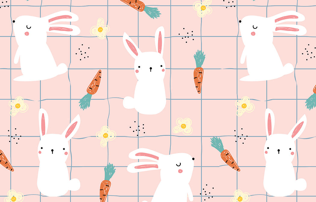 Easter-themed pattern featuring adorable white bunnies with pink ears, orange carrots with green tops, small yellow flowers, and black speckles on a pastel pink background with a subtle blue grid