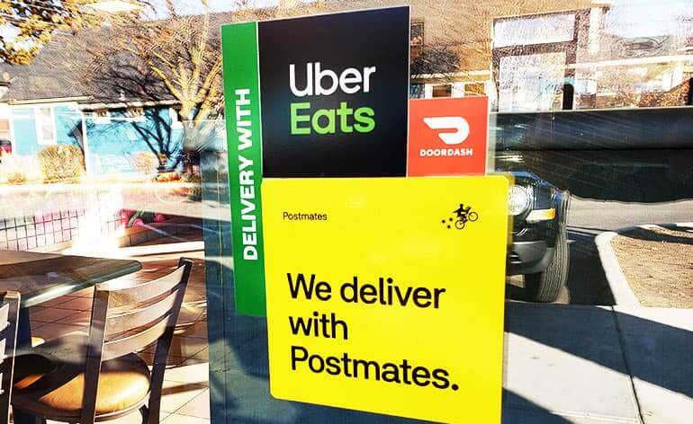 Sign on a business highlighting food delivery apps