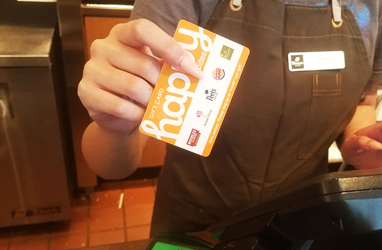Cashier holding a Happy Card